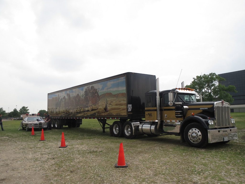 Long-nose semi truck with a painted trailer