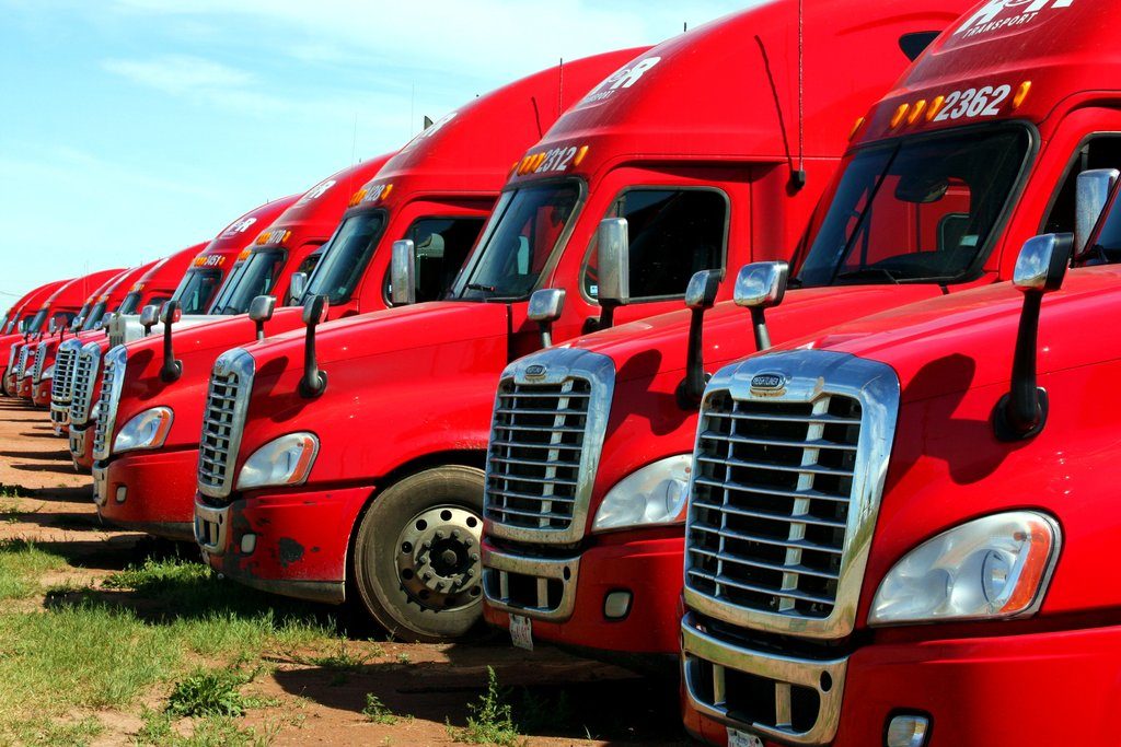 Row of red semi tractors parked in a line